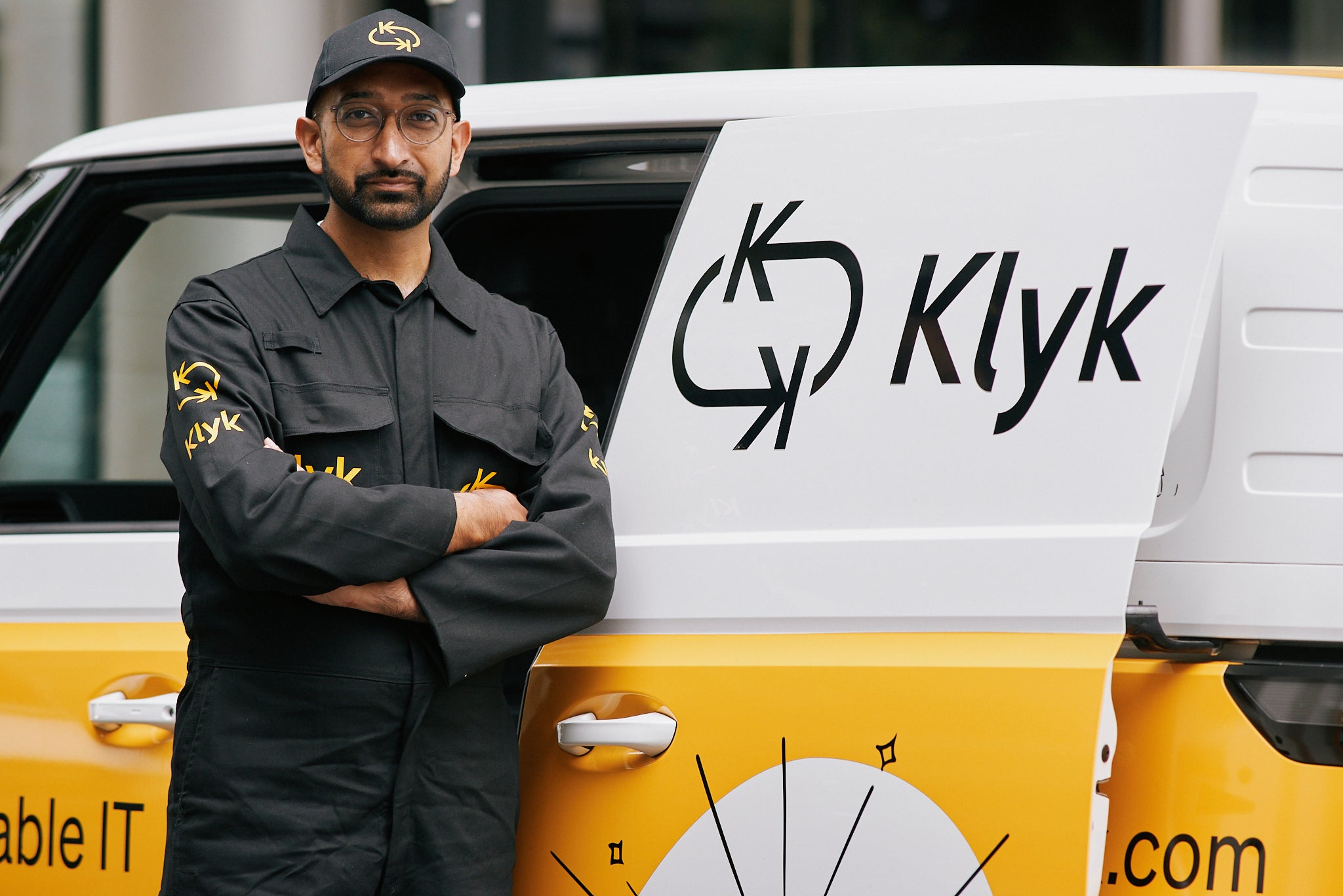 A Klyk engineer standing beside a Klyk van