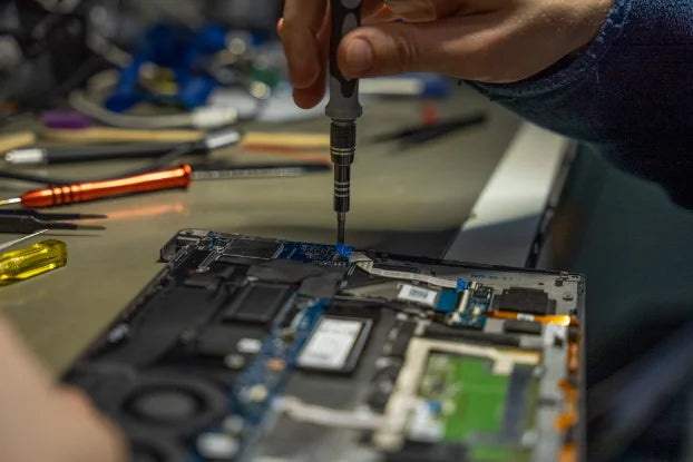 Engineer repairing a laptop